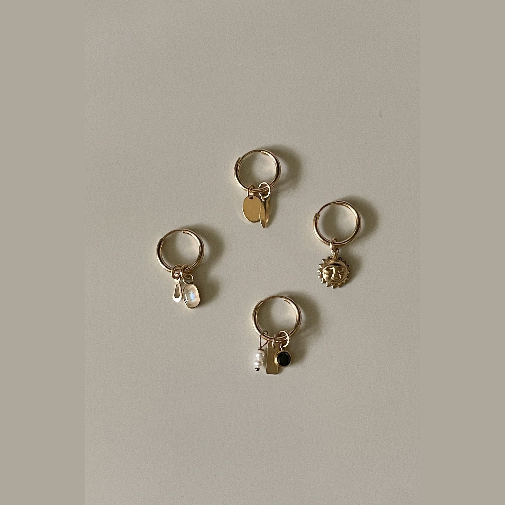 Gold sleeper earrings on sale with charm